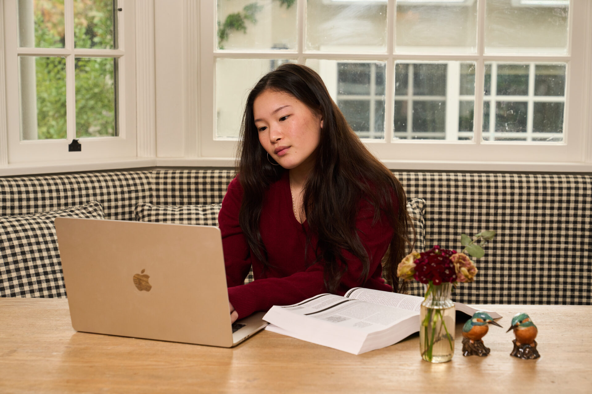 Student writing the Common App personal statement at a desk with a notebook
